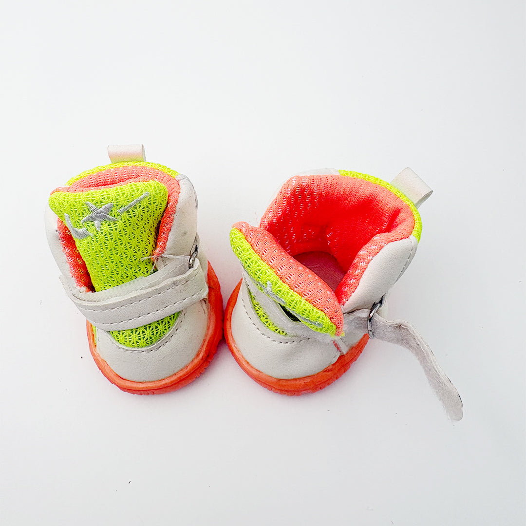 Adjustable velcro strap design on neon green dog shoes for secure fit