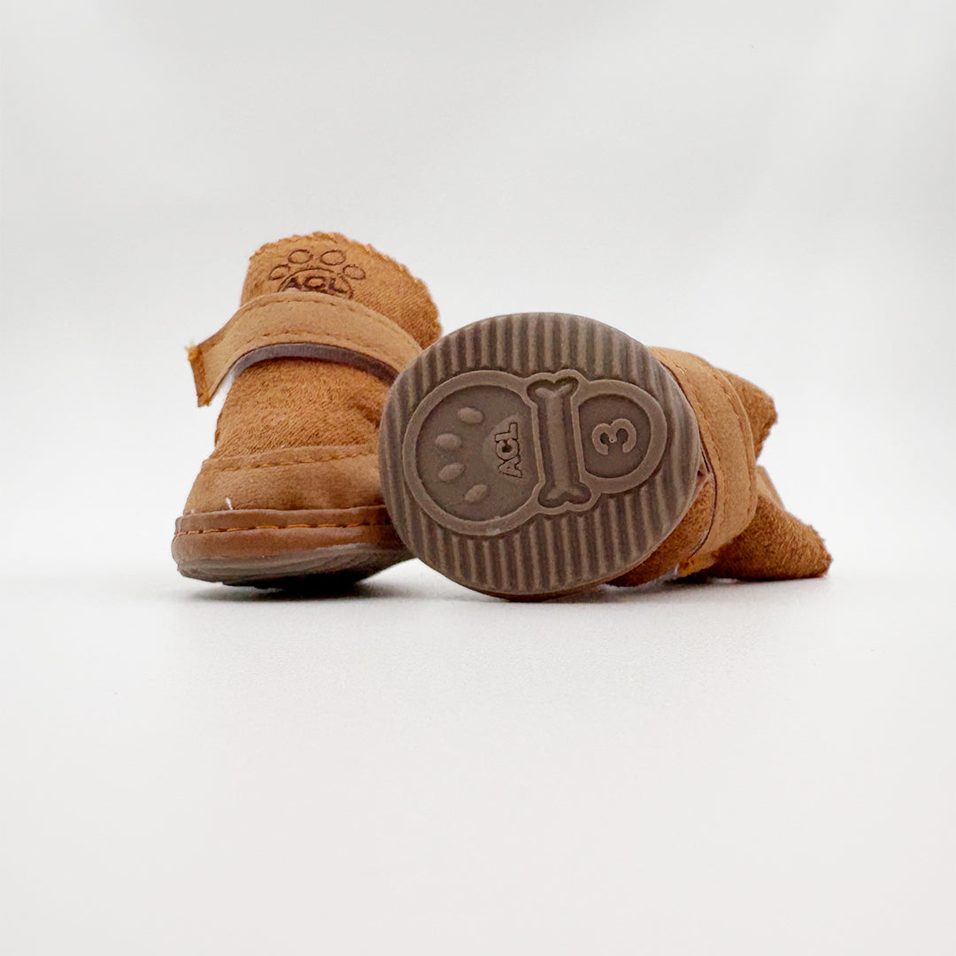 Adorable pug dog walking in brown non-slip shoes – comfortable pet footwear for winter walks