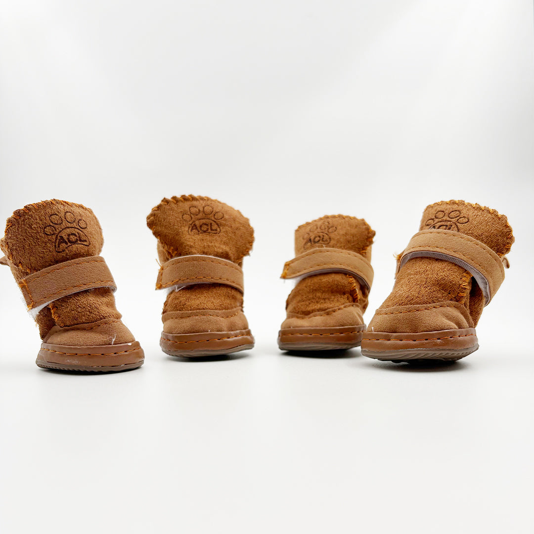 Four pairs of brown dog boots with velcro straps